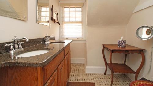 a bathroom with a sink and a mirror at Saltwood House in Cape May
