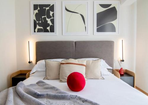 a red ball sits on top of a bed at SANTA FE Red Beautiful Apartment! in Mexico City