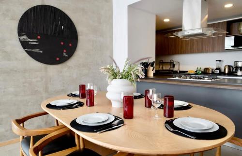 a wooden table in a kitchen with a dining room at SANTA FE Red Beautiful Apartment! in Mexico City