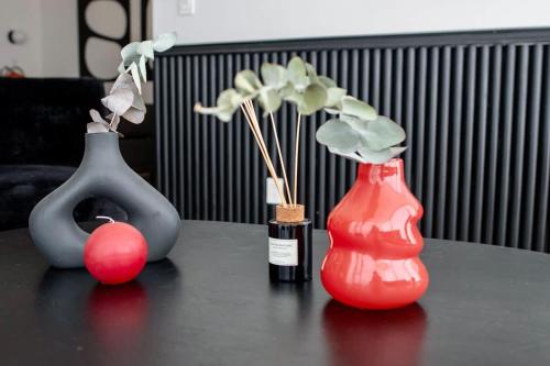 three vases sitting on top of a table at SANTA FE Red Beautiful Apartment! in Mexico City