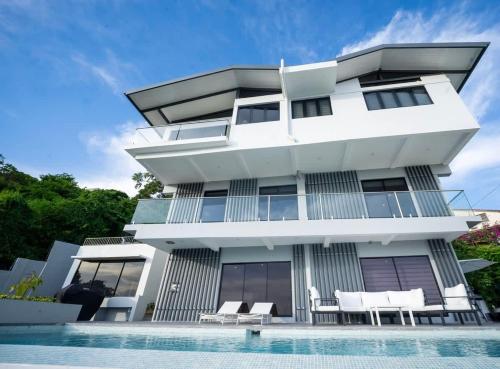 a house with a swimming pool in front of it at Avaya Oasis - Villa Trinidad in Carenage