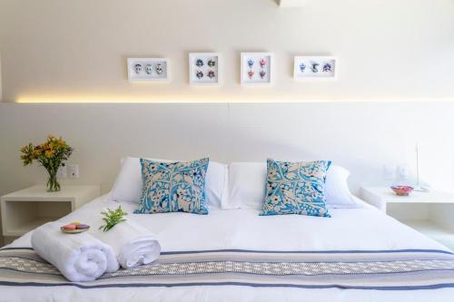 a white bed with pillows and towels on it at Dazzling house in the heart of Coyoacan/12 guests in Mexico City