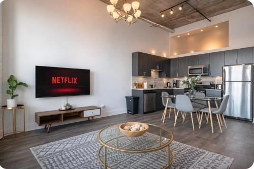 a living room with a kitchen and a dining room at Convenient Cozy 2BR Loft with Optional Parking for 8 guests Near McCormick Place, Soldier Field and Lakefront Trail in Chicago