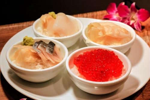 four bowls of food on a plate on a table at Hotel Torifito Otaru Canal in Otaru