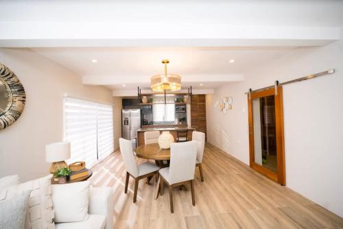 a dining room and kitchen with a table and chairs at Avaya Oasis - Suriname Suite in Carenage