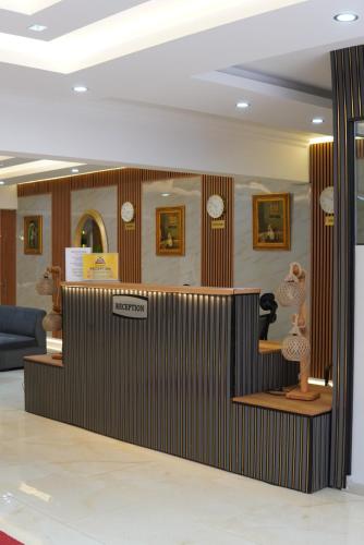 a room with clocks on the wall and a lobby at GoldHome Apart Otel in Famagusta