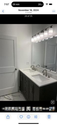 a bathroom with a sink and a large mirror at Blessed Homes in East Orange