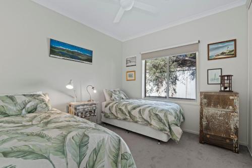 a bedroom with two beds and a window at The Buckleys Escape in Point Lonsdale