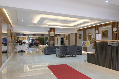 a lobby with couches and chairs in a building at GoldHome Apart Otel in Famagusta