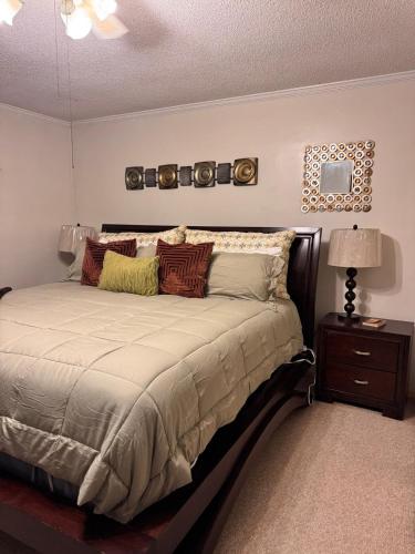 a bedroom with a large bed with pillows at The Tee Time Cottage in Augusta