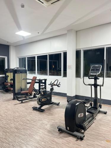 a gym with several exercise equipment in a room at Primavera Citta Verde in Balulang