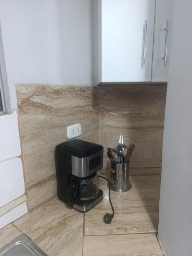 a coffee maker on the corner of a kitchen at Minidepartamento Centro de Huanuco in Huánuco