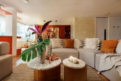 a living room with a couch and two tables with candles at Amazing TERRAZO place, 8 guest!! 4 beds in Mexico City