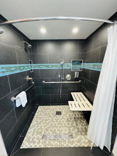 a bathroom with a shower and a bench in it at The Lexmar - Dodger Stadium Hollywood in Los Angeles
