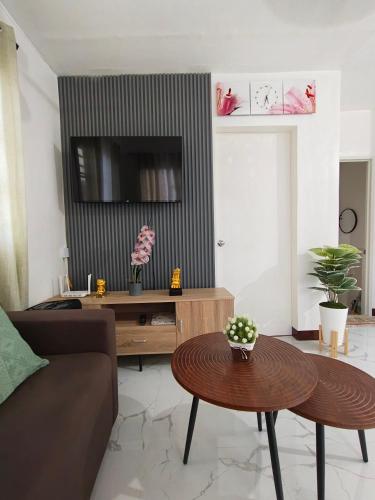a living room with a couch and a table at Sorelle Haven II in Manolo Fortich