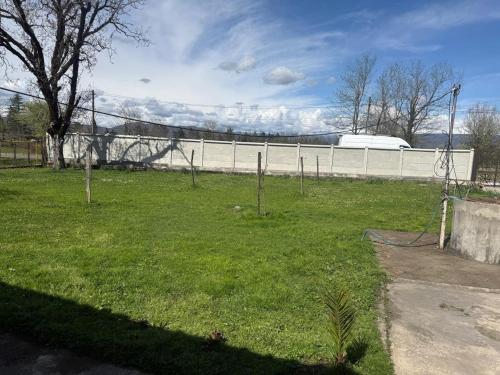 a yard with a fence and a field of grass at BibO in Martvili