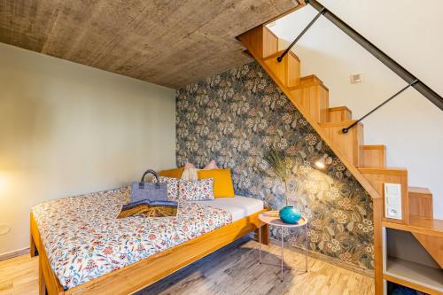 a bedroom with a bed and a staircase at Penzion U Kapličky in Znojmo
