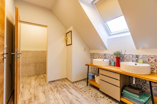 a bathroom with two sinks and a shower at Penzion U Kapličky in Znojmo