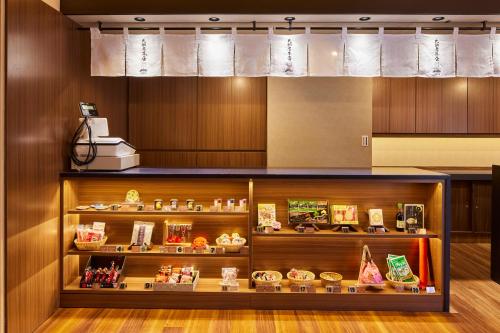 a display case in a room with food items at Yamatoya Honten Ryokan Osaka in Osaka