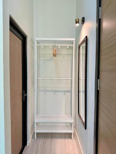 an empty refrigerator with its door open in a hallway at NitaDinn Guest House in Kampong Ru Sepuloh