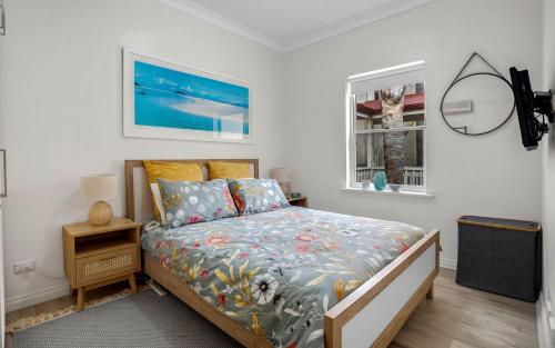 a bedroom with a bed and a window at No 11 The Smugglers Inn in Victor Harbor