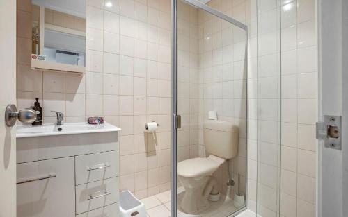 a bathroom with a shower and a toilet and a sink at No 11 The Smugglers Inn in Victor Harbor