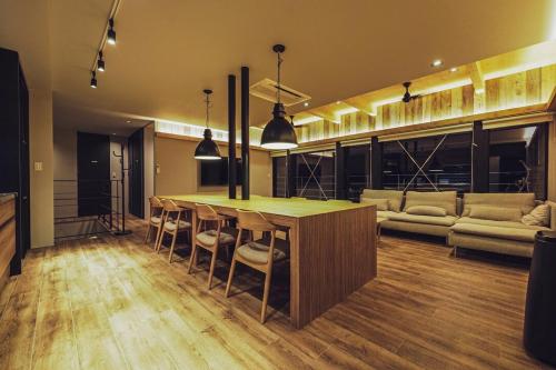 a living room with a table and a couch at ZABOCON Yoichi Villa in Yoichi