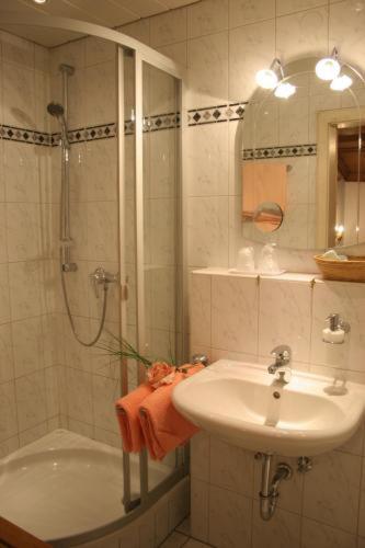 a bathroom with a shower and a sink and a shower at Alpenrose in Mittenwald