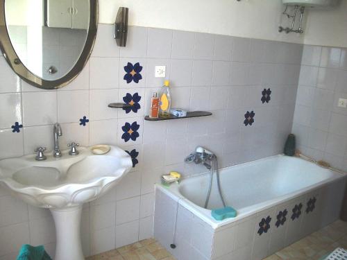 a bathroom with a sink and a tub and a mirror at Sweet Home in Montopoli in Sabina