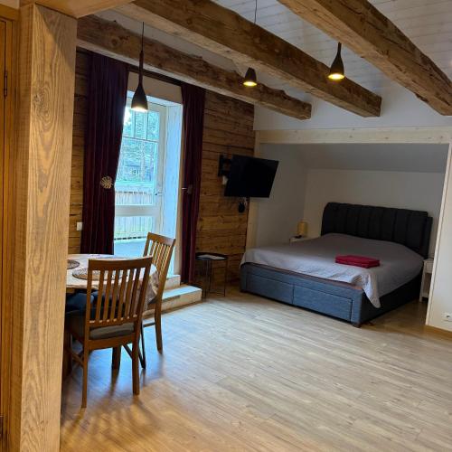 a bedroom with a bed and a table and chairs at Nõmme Apartments in Tallinn