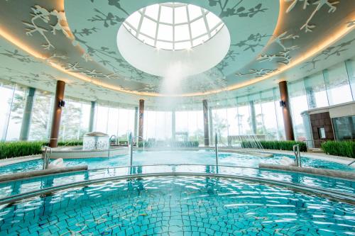 a swimming pool in a building with a ceiling at Hilton Odawara Resort & Spa in Odawara