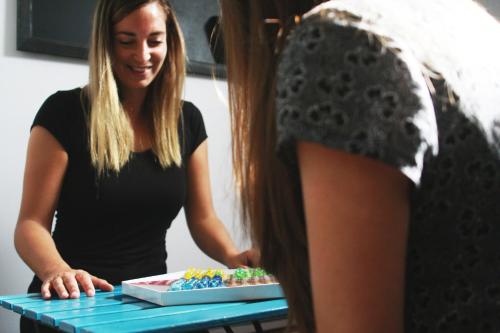 a woman standing in front of a table with a cake at The Lights Hostel in Málaga