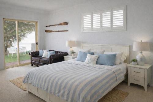 a bedroom with a bed and a chair and a window at St Helens in Edithburgh