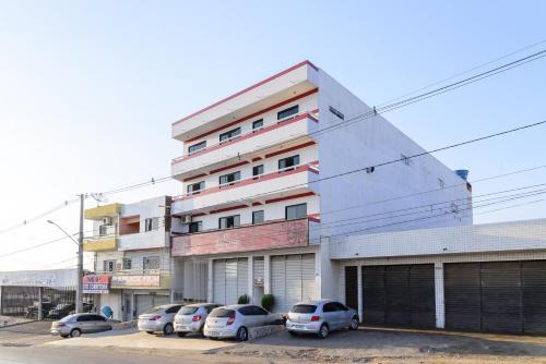 a building with cars parked in front of it at Hotel Rota do Sertão in Serra Talhada