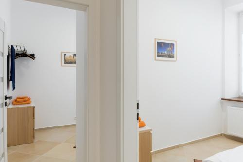 a room with white walls and a door with three pictures at Apartment In the Heart of Warsaw in Warsaw