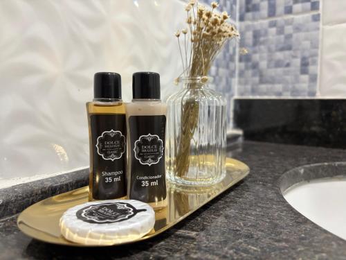 two bottles of essential oils on a tray next to a sink at Julietta House Hotel in Manaus