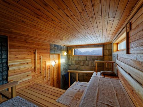 a wooden room with a bed in a sauna at Sauna Paistaa in Sobetsu