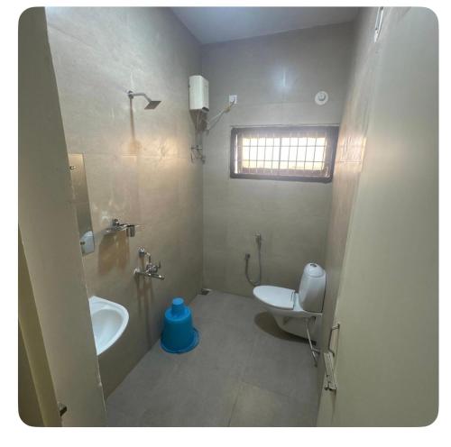 a bathroom with a sink and a toilet at Trichy homestays in Tiruchirappalli