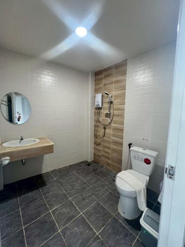 a bathroom with a toilet and a sink and a shower at อยู่สบายเพลส in Chonnabot