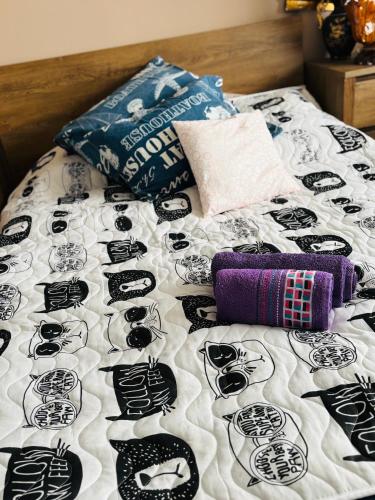 a bed with black and white pillows on it at Experience at Malinova dolina in Sofia