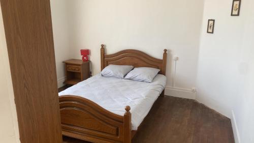a bed with two pillows on it in a bedroom at Champvert in Champvert