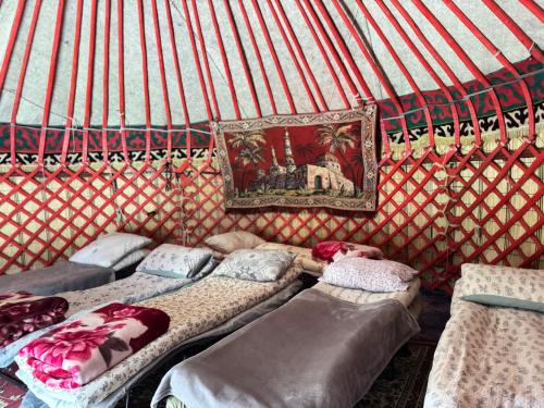 a room with four beds in a yurt at "Ethno Yurt Camp Argymak" Altyn Arashan in Mineralʼnyy Istochnik Altyn-Arasan