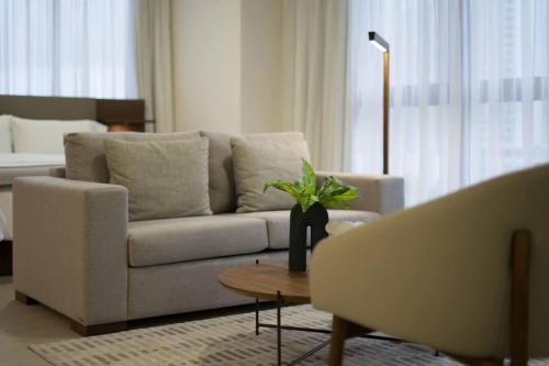 a living room with a white couch and a table at Deluxe Loft Apt with City View in Panama City