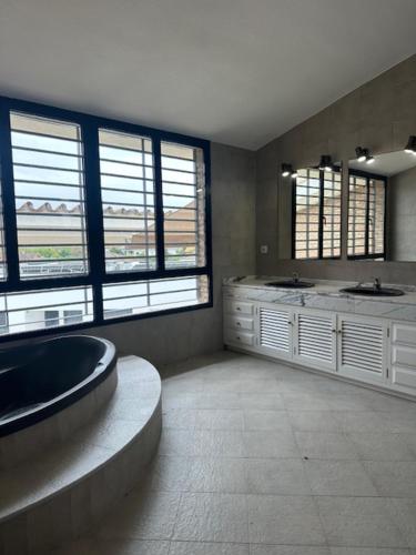 a large bathroom with a tub and two sinks at El Puente de Sansueña in Córdoba