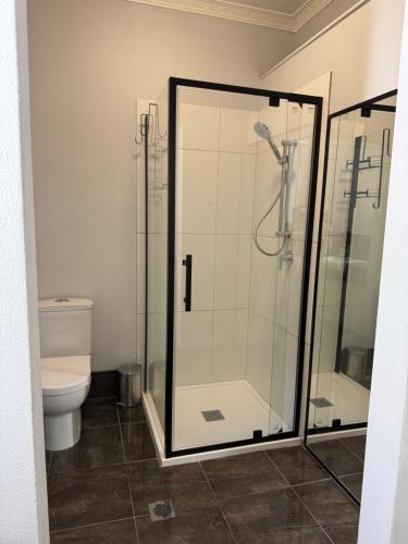 a bathroom with a shower and a toilet at North Central Holiday Home in North Mackay