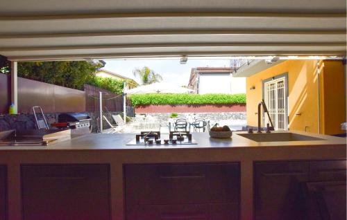 a kitchen with a sink and a counter top at Maison De Paris in San Giovanni la Punta