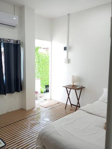 a bedroom with a bed and a door to a patio at BN Residence in Ko Tao