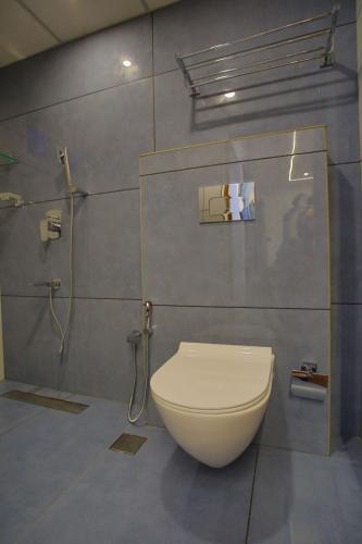 a bathroom with a toilet and a shower at Nature Shade Pool Villa in Anachal