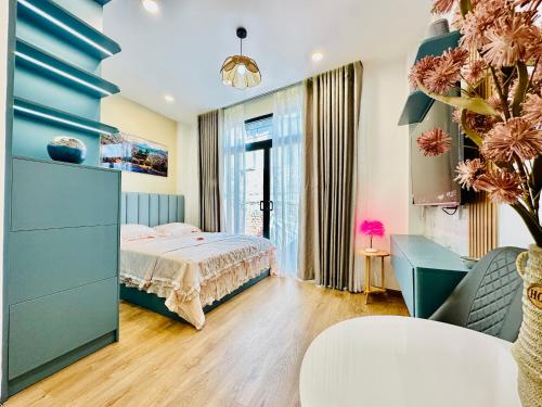 a bedroom with a bed and a blue wall at Myla House in Ho Chi Minh City
