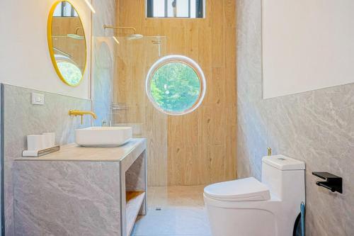 a bathroom with a toilet and a sink and a window at v27 Sunset Horizon Villa Seaview in Haad Yao